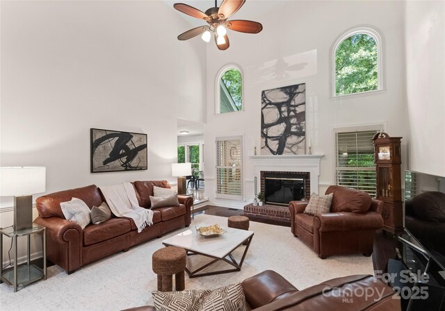 9141 Covey Hollow Ct, Charlotte, NC 28210 - living area with a towering ceiling, a ceiling fan, and a brick fireplace