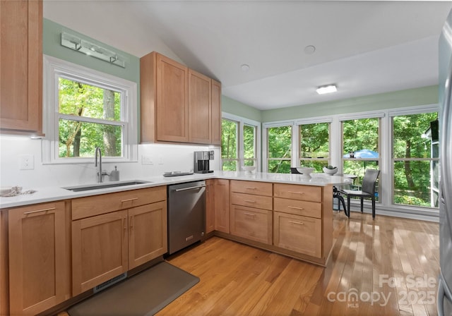 9141 Covey Hollow Ct, Charlotte, NC 28210 - kitchen with dishwasher, a peninsula, light countertops, vaulted ceiling, and light wood-style floors