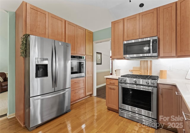 9141 Covey Hollow Ct, Charlotte, NC 28210 - kitchen with stainless steel appliances, light wood-type flooring, and light countertops