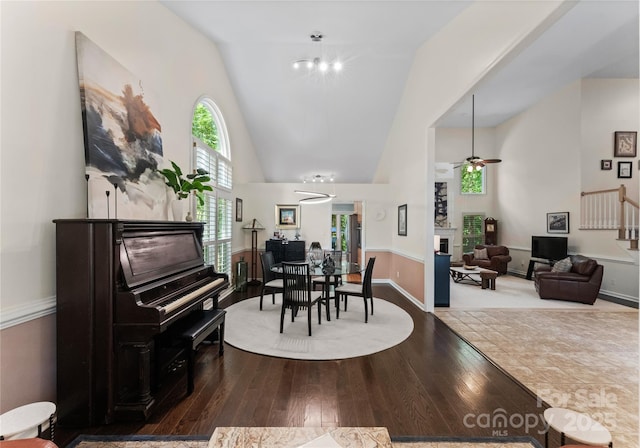 9141 Covey Hollow Ct, Charlotte, NC 28210 - dining area with a fireplace, high vaulted ceiling, a ceiling fan, and wood finished floors