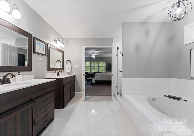 9141 Covey Hollow Ct, Charlotte, NC 28210 - ensuite bathroom featuring a bath, two vanities, and a shower stall