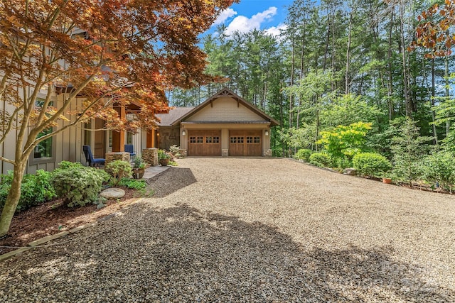 429 Turtle Head Dr, Nebo, NC 28761 - view of front of house with gravel driveway, a garage, stone siding, and board and batten siding