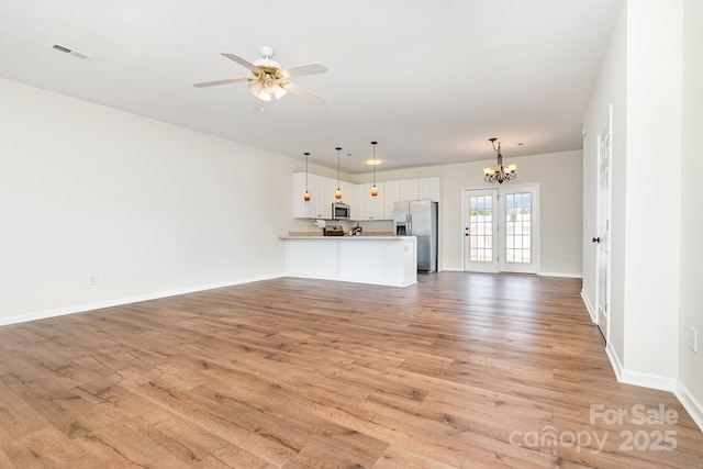 28 Ridgestone Cir, Mauldin, SC 29662 - unfurnished living room with a chandelier, light wood-type flooring, and ceiling fan