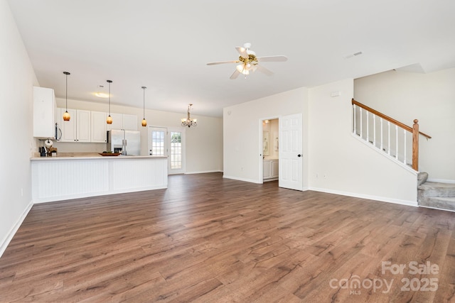 28 Ridgestone Cir, Mauldin, SC 29662 - unfurnished living room with wood finished floors, stairway, a ceiling fan, and a chandelier