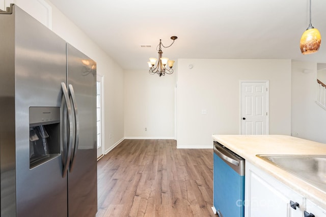 28 Ridgestone Cir, Mauldin, SC 29662 - kitchen with stainless steel fridge with ice dispenser, dishwashing machine, light wood-type flooring, white cabinetry, and a chandelier
