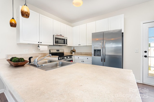 28 Ridgestone Cir, Mauldin, SC 29662 - kitchen featuring appliances with stainless steel finishes, a peninsula, wood finished floors, light countertops, and white cabinets