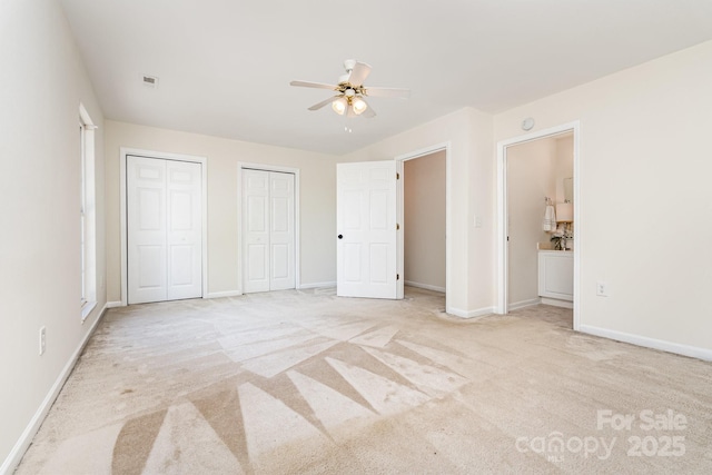 28 Ridgestone Cir, Mauldin, SC 29662 - unfurnished bedroom featuring multiple closets, light carpet, and a ceiling fan
