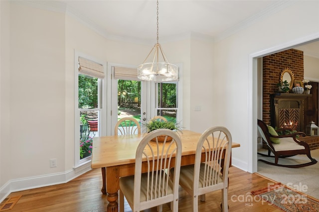 5008 Saddle Horn Trl, Weddington, NC 28104 - dining space with a chandelier, healthy amount of natural light, light wood-type flooring, and ornamental molding