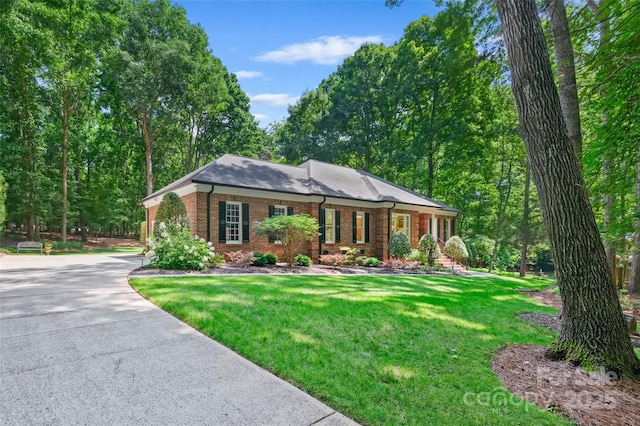 5008 Saddle Horn Trl, Weddington, NC 28104 - view of front of house with brick siding, a front lawn, and concrete driveway