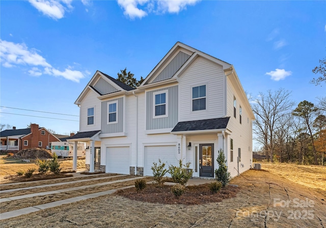 9709 Misenheimer Rd Unit 4A, Charlotte, NC 28215 - view of front facade featuring board and batten siding, an attached garage, dirt driveway, and stone siding