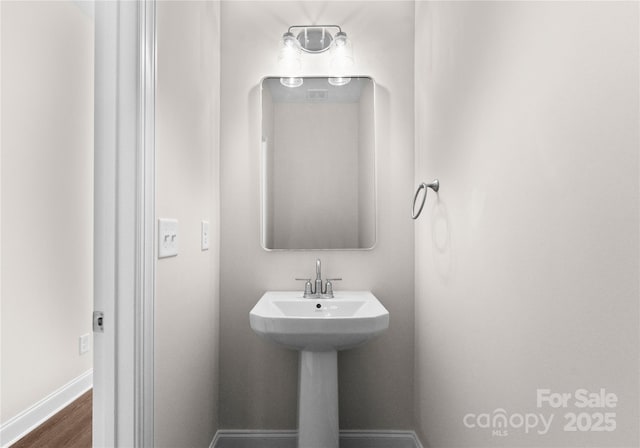 9709 Misenheimer Rd Unit 4A, Charlotte, NC 28215 - bathroom with baseboards and wood finished floors