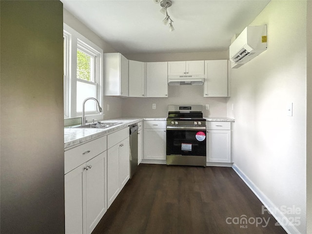 36 Graybark Ct, Waynesville, NC 28786 - kitchen featuring appliances with stainless steel finishes, under cabinet range hood, a wall mounted air conditioner, light countertops, and white cabinetry