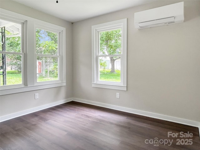 36 Graybark Ct, Waynesville, NC 28786 - empty room featuring a wall mounted AC, healthy amount of natural light, and dark wood-type flooring