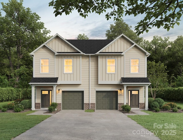7300 Boswell Rd Unit 4A, Charlotte, NC 28215 - view of front of house with board and batten siding, an attached garage, driveway, brick siding, and a front yard