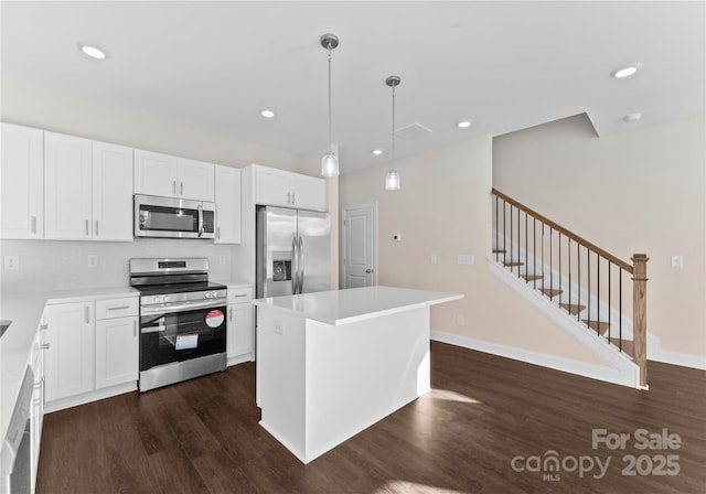 7300 Boswell Rd Unit 4A, Charlotte, NC 28215 - kitchen with appliances with stainless steel finishes, dark wood-style floors, white cabinetry, and recessed lighting