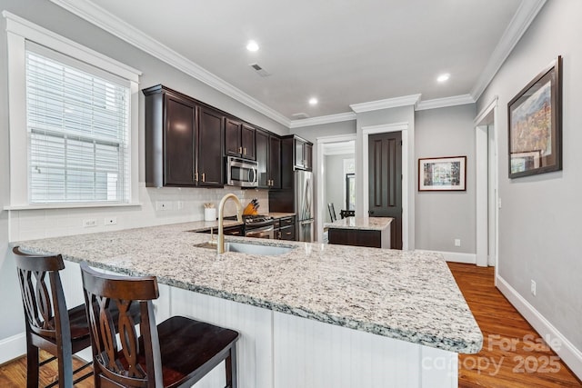 739 Terrace Park, Rock Hill, SC 29730 - kitchen with appliances with stainless steel finishes, tasteful backsplash, dark brown cabinets, a peninsula, and wood finished floors