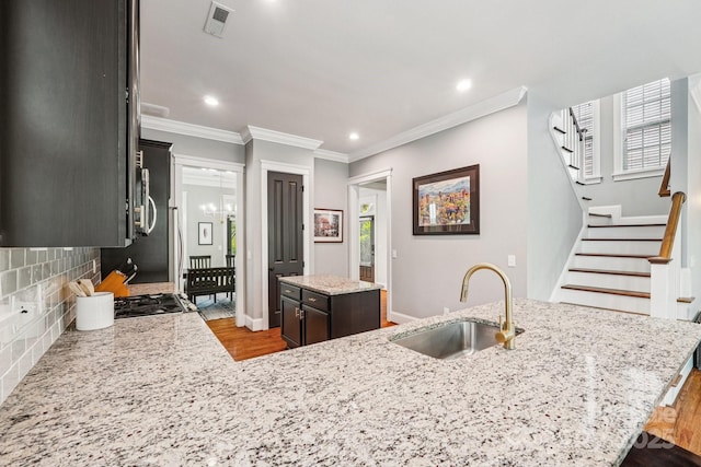 739 Terrace Park, Rock Hill, SC 29730 - kitchen with a kitchen island, wood finished floors, backsplash, crown molding, and light stone countertops