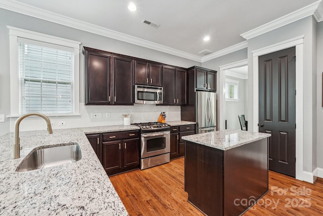 739 Terrace Park, Rock Hill, SC 29730 - kitchen featuring appliances with stainless steel finishes, decorative backsplash, dark brown cabinets, light stone counters, and crown molding
