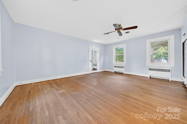 422 Wagner St, Troutman, NC 28166 - spare room with radiator heating unit, a ceiling fan, and hardwood / wood-style floors