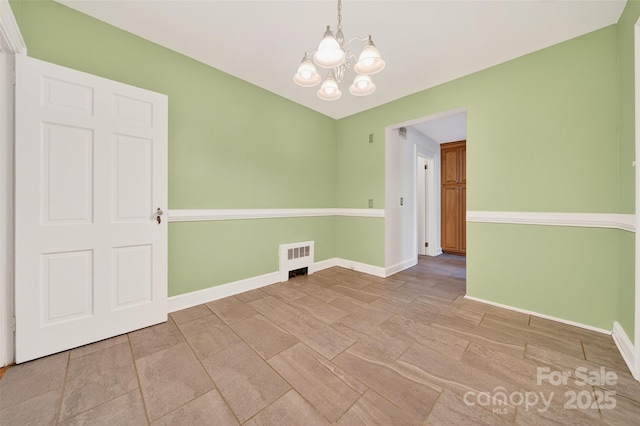 422 Wagner St, Troutman, NC 28166 - spare room with a chandelier and baseboards