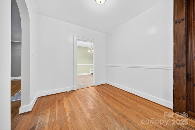 422 Wagner St, Troutman, NC 28166 - unfurnished bedroom with arched walkways, wood-type flooring, and ornamental molding