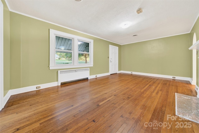 422 Wagner St, Troutman, NC 28166 - unfurnished room with radiator heating unit, crown molding, and wood-type flooring