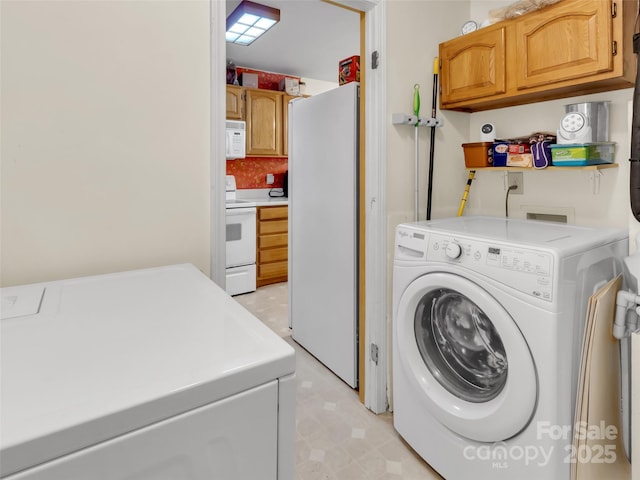 57 Copperhead Cv, Sylva, NC 28779 - laundry room featuring cabinet space, washing machine and dryer, and light flooring