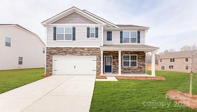 462 Janie Cir Unit 100, Newton, NC 28658 - craftsman-style house with stone siding, a porch, concrete driveway, and a front lawn