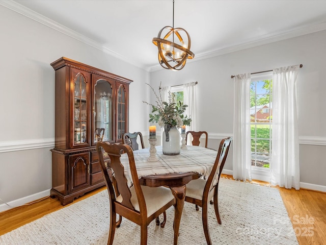 11126 Windgate Ct, Tega Cay, SC 29708 - dining area with a chandelier, light wood-style floors, and ornamental molding