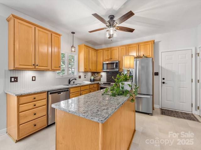 11126 Windgate Ct, Tega Cay, SC 29708 - kitchen featuring appliances with stainless steel finishes, light stone counters, backsplash, ceiling fan, and a kitchen island