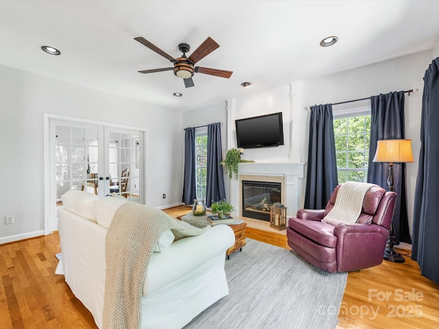 11126 Windgate Ct, Tega Cay, SC 29708 - living area featuring french doors, plenty of natural light, a ceiling fan, wood finished floors, and recessed lighting