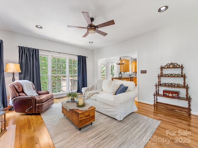 11126 Windgate Ct, Tega Cay, SC 29708 - living room with a ceiling fan, light wood-type flooring, recessed lighting, and a chandelier