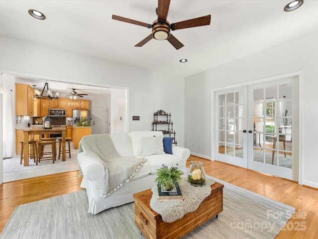 11126 Windgate Ct, Tega Cay, SC 29708 - living area with ceiling fan, french doors, light wood-type flooring, recessed lighting, and a chandelier