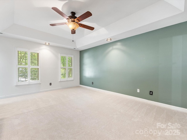 11126 Windgate Ct, Tega Cay, SC 29708 - empty room with a raised ceiling, light colored carpet, and a ceiling fan