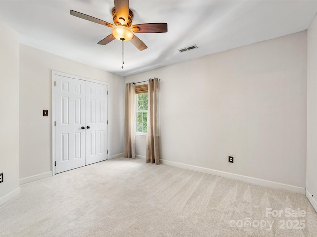 11126 Windgate Ct, Tega Cay, SC 29708 - unfurnished bedroom featuring light carpet, a closet, and a ceiling fan