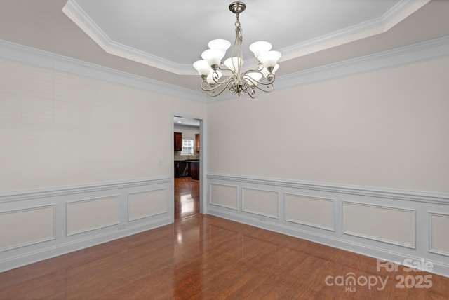 8325 Burgundy Ridge Dr, Harrisburg, NC 28075 - empty room featuring a chandelier, crown molding, wood finished floors, wainscoting, and a tray ceiling