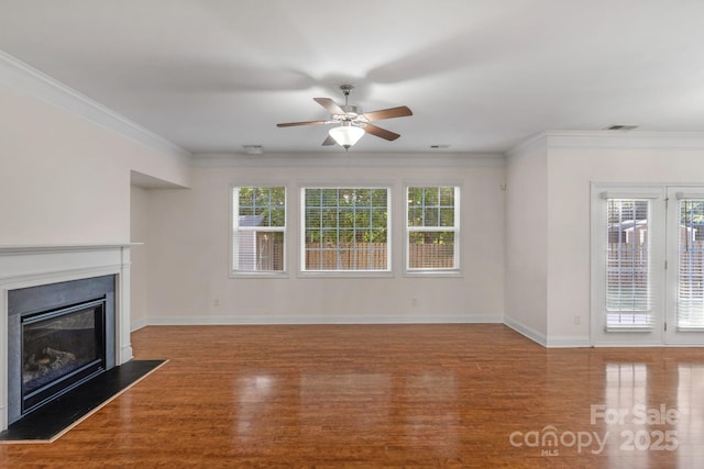 8325 Burgundy Ridge Dr, Harrisburg, NC 28075 - unfurnished living room with wood finished floors, ceiling fan, a glass covered fireplace, and ornamental molding