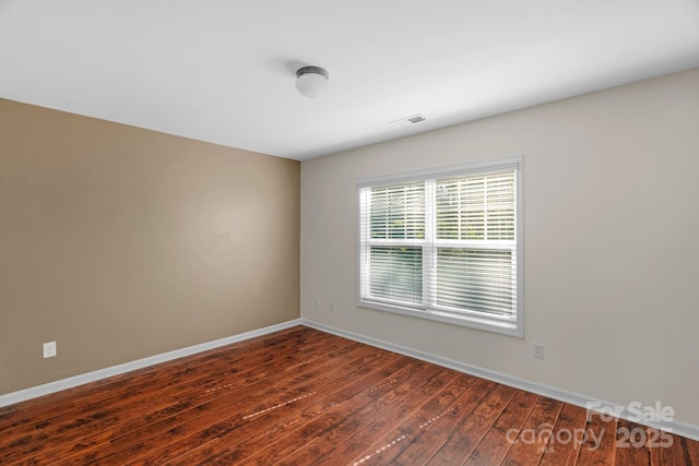 8325 Burgundy Ridge Dr, Harrisburg, NC 28075 - spare room featuring wood finished floors and baseboards