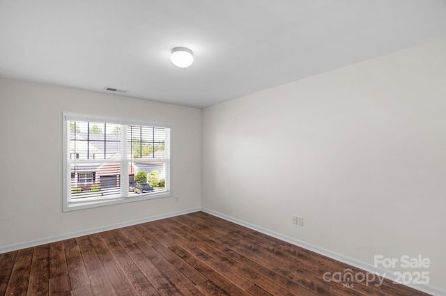 8325 Burgundy Ridge Dr, Harrisburg, NC 28075 - empty room featuring dark wood-style floors and baseboards