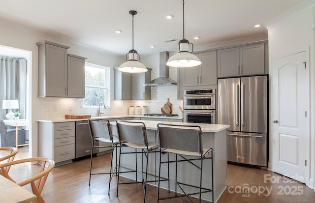 1041 Waxhaw Crossing Dr Unit 058, Waxhaw, NC 28173 - kitchen with stainless steel appliances, wall chimney exhaust hood, gray cabinets, light countertops, and backsplash