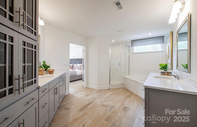1041 Waxhaw Crossing Dr Unit 058, Waxhaw, NC 28173 - bathroom featuring vanity, a stall shower, a bath, wood finished floors, and ensuite bath