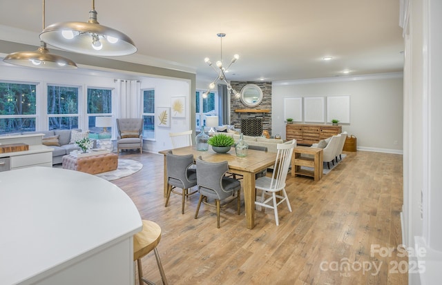 1041 Waxhaw Crossing Dr Unit 058, Waxhaw, NC 28173 - dining area with ornamental molding, a fireplace, light wood-style flooring, and recessed lighting