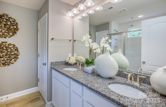 1041 Waxhaw Crossing Dr Unit 058, Waxhaw, NC 28173 - full bathroom with double vanity, wood finished floors, and a shower stall