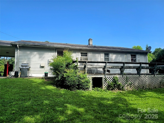 1206 Three Way Ln, Lenoir, NC 28645 - rear view of house featuring a lawn, a wooden deck, and a chimney