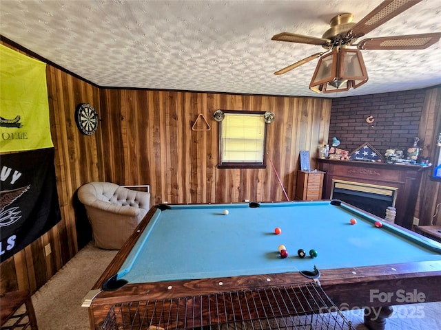 1206 Three Way Ln, Lenoir, NC 28645 - rec room with wooden walls, billiards table, ceiling fan, a fireplace, and a textured ceiling