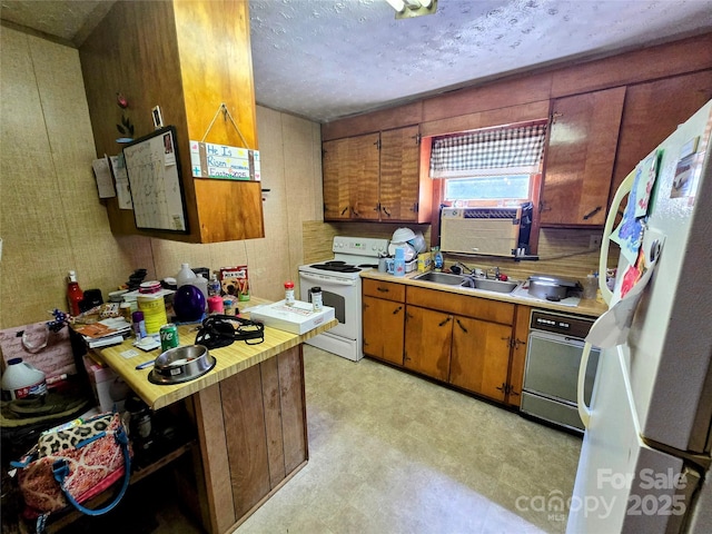 1206 Three Way Ln, Lenoir, NC 28645 - kitchen with white appliances, light flooring, light countertops, brown cabinets, and a textured ceiling
