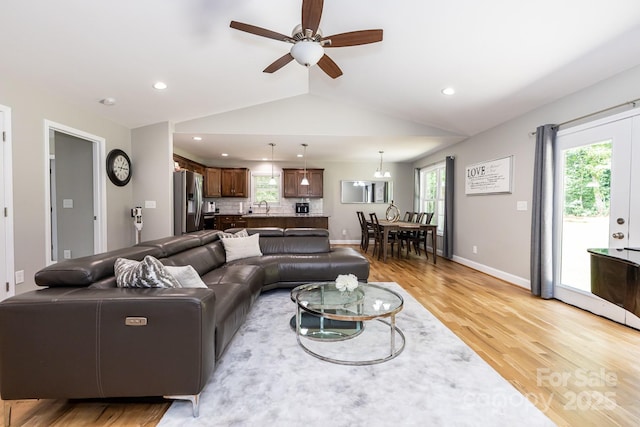 1005 8th Ave SW, Conover, NC 28613 - living room with vaulted ceiling, light wood finished floors, ceiling fan, and recessed lighting