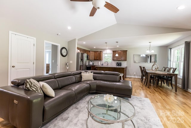 1005 8th Ave SW, Conover, NC 28613 - living room featuring lofted ceiling, light wood-type flooring, a ceiling fan, recessed lighting, and a chandelier