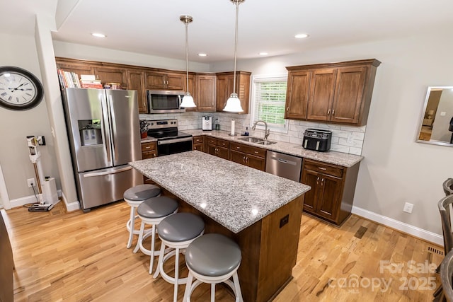 1005 8th Ave SW, Conover, NC 28613 - kitchen with stainless steel appliances, light wood finished floors, decorative backsplash, and recessed lighting