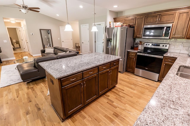 1005 8th Ave SW, Conover, NC 28613 - kitchen featuring stainless steel appliances, light wood finished floors, open floor plan, a ceiling fan, and lofted ceiling